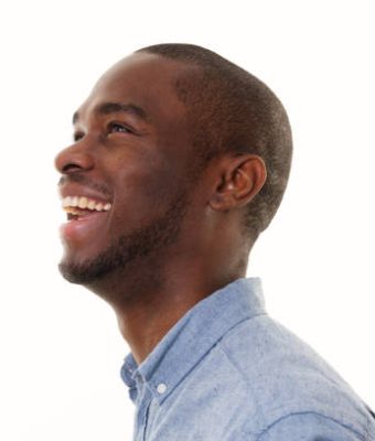 Close up side portrait of laughing african american man looking up